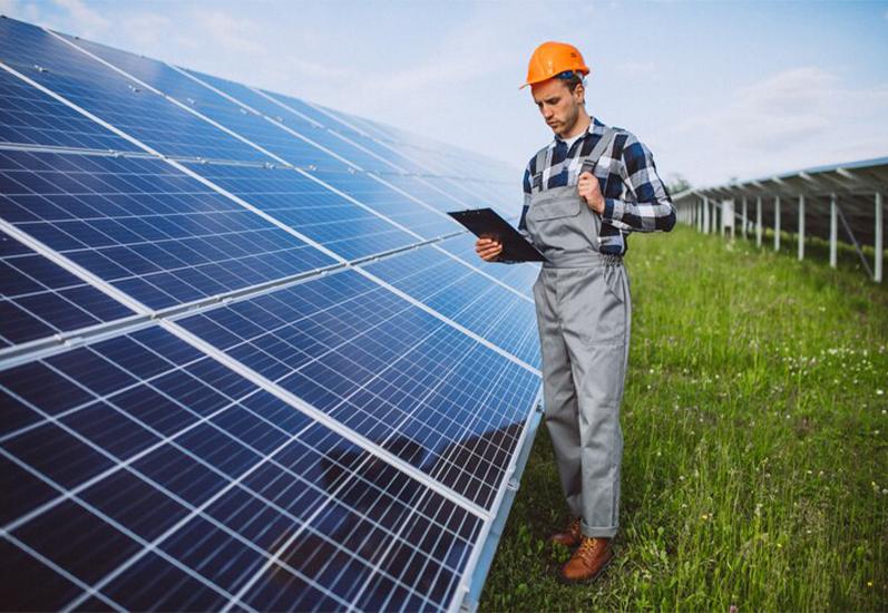 A solar technician inspecting a solar panel for maintenance and repair, ensuring optimal energy efficiency.
